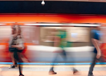 Dynamic scene of commuters in a subway station with motion blur capturing the rush.